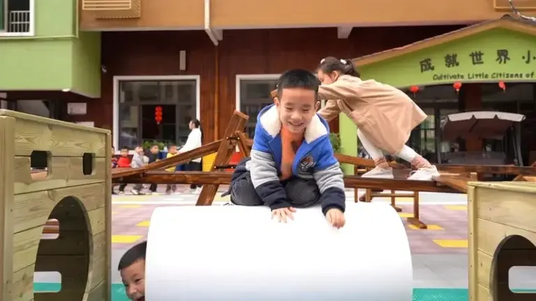 Children experiencing joy and true play with anji play equipment in natural outdoor kindergarten environment